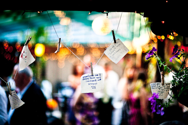 notes to the bride and groom from the guests hanging pinned to a line at the reception - photo by New Mexico based wedding photographers Twin Lens